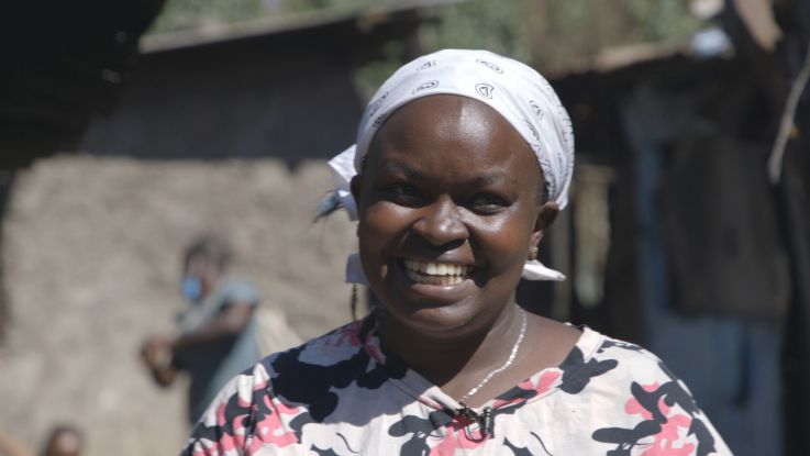 Wanja is delighted at the opening of a new water, sanitation and hygiene (WASH) facility in City Carton, Kenya. Africa Youth Trust/ActionAid